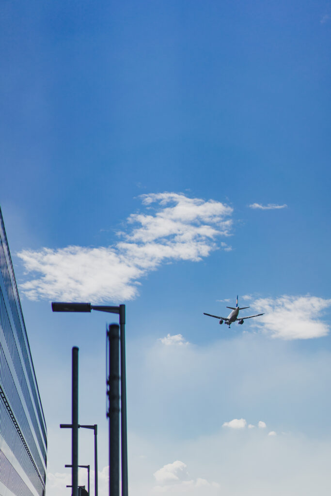the plane is flying in the blue sky